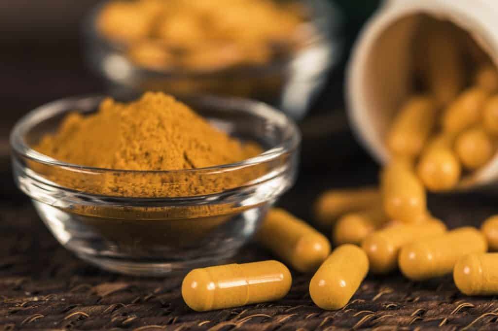 Curcumin Herbal Supplement Capsules and Turmeric Powder