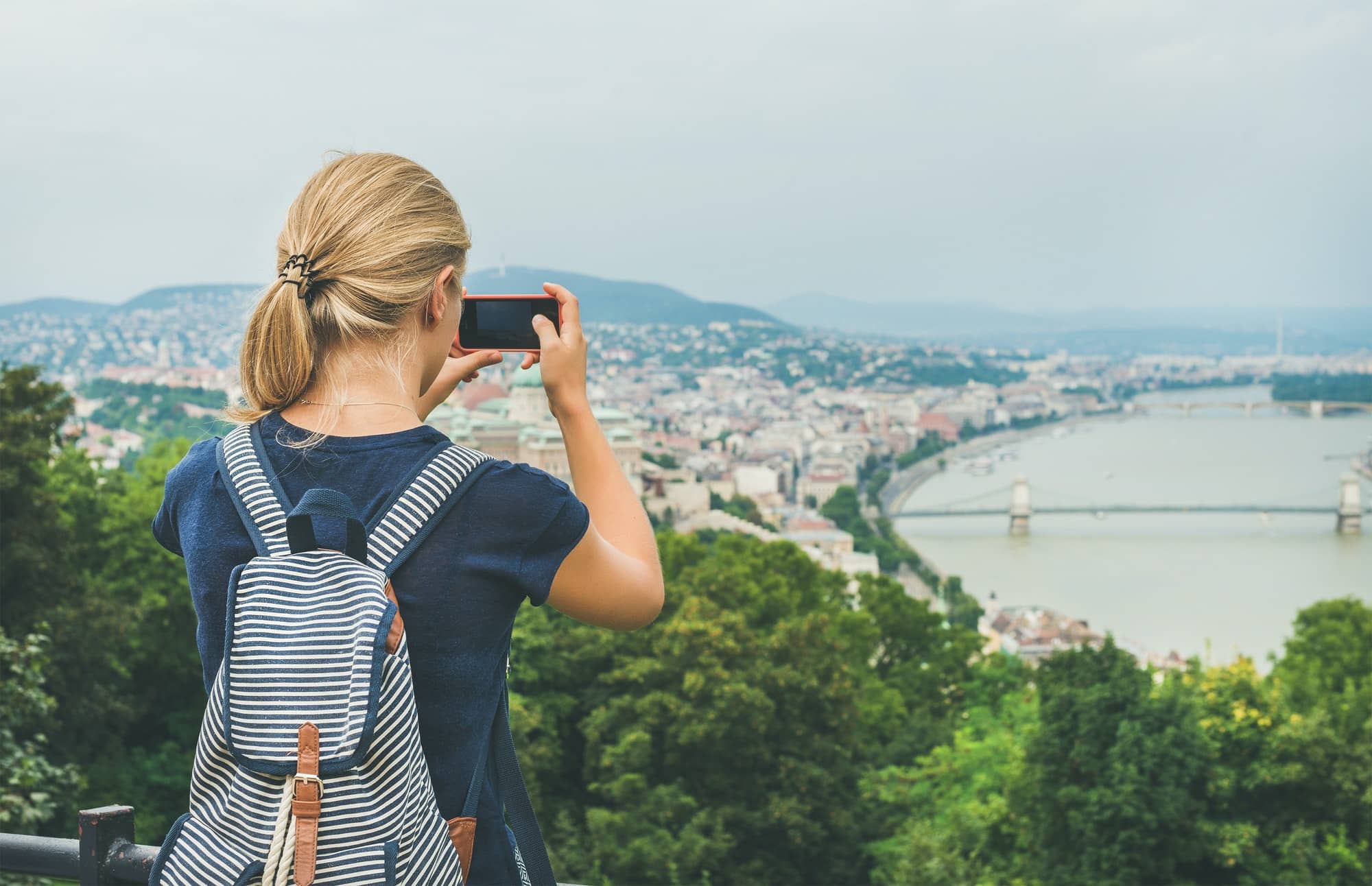 Young woman making photoes of Danube river and Budapest, Hungary